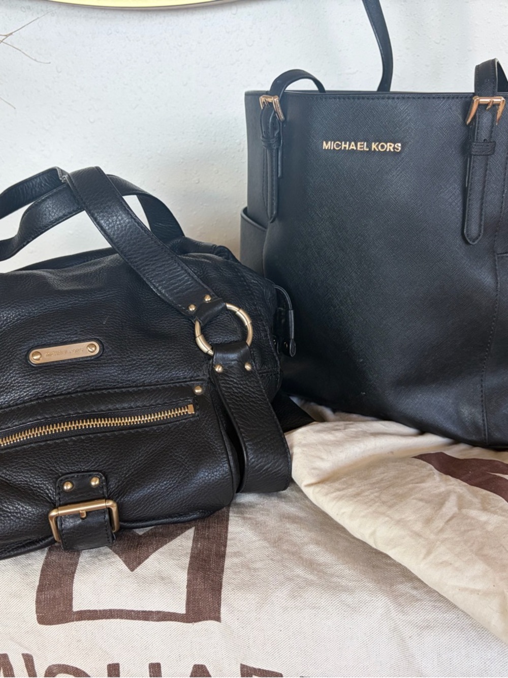 Two vintage Michael Kors’ bags: black satchel and tote
